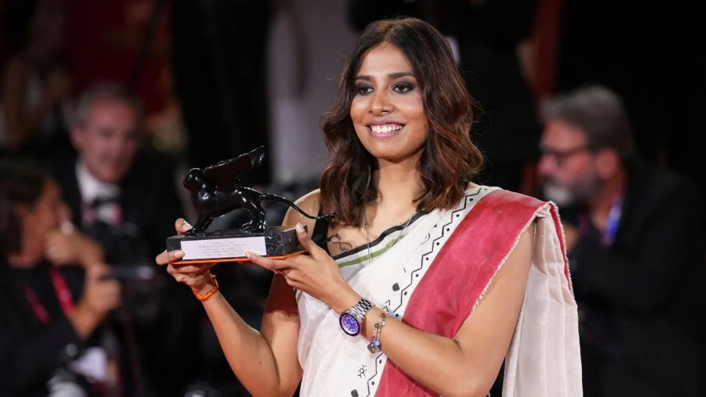 Indian Filmmaker Anuparna Roy holding the Best Director award in the Orizzonti section at the 82nd Venice Film Festival.