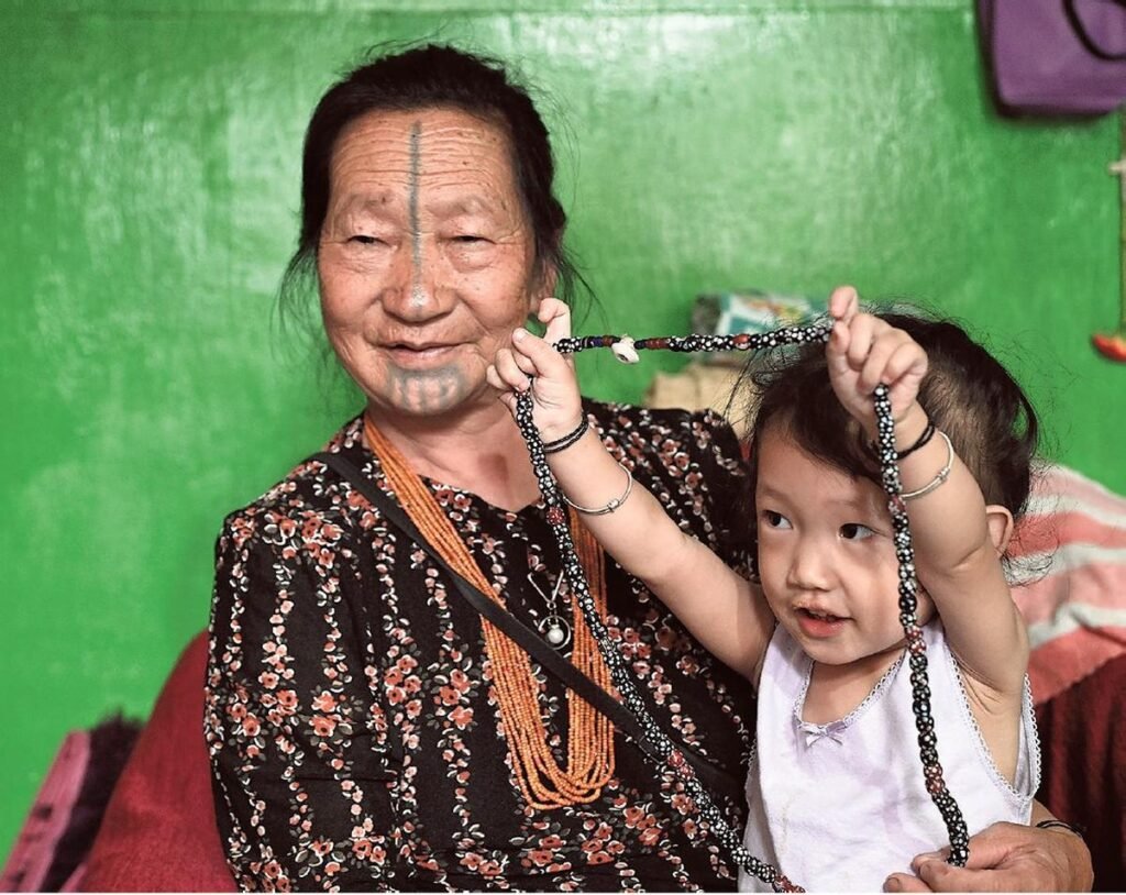 A woman from the Apatani Tribe playing with her granddaughter